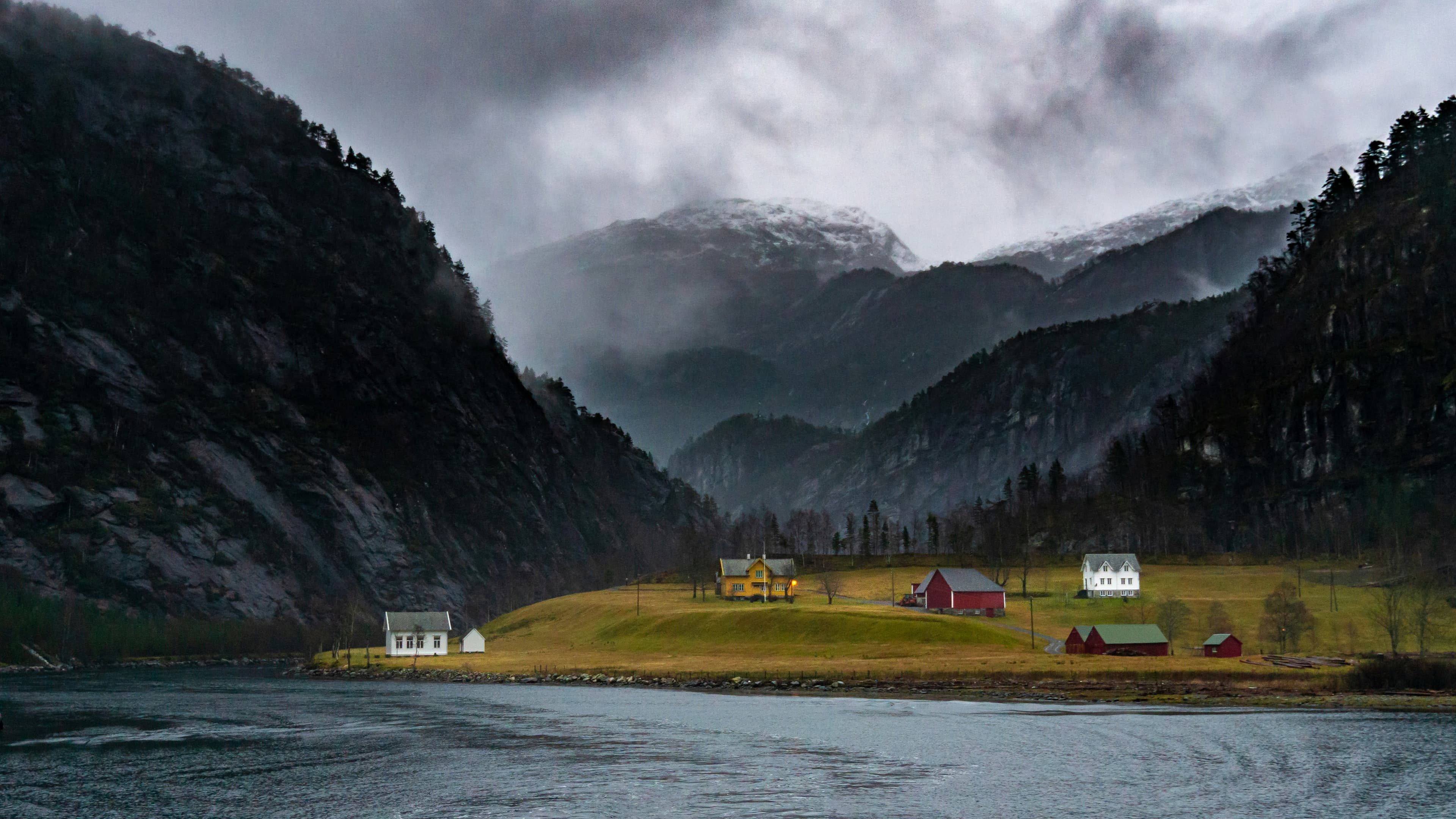 Norwegian fjord village with houses and mountains in summer